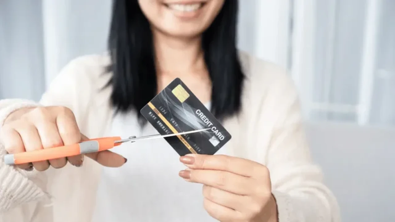 Close up on a plate of mashed potatoes, topped with baked pork chops with cream of mushroom soup, and a side of green beans.