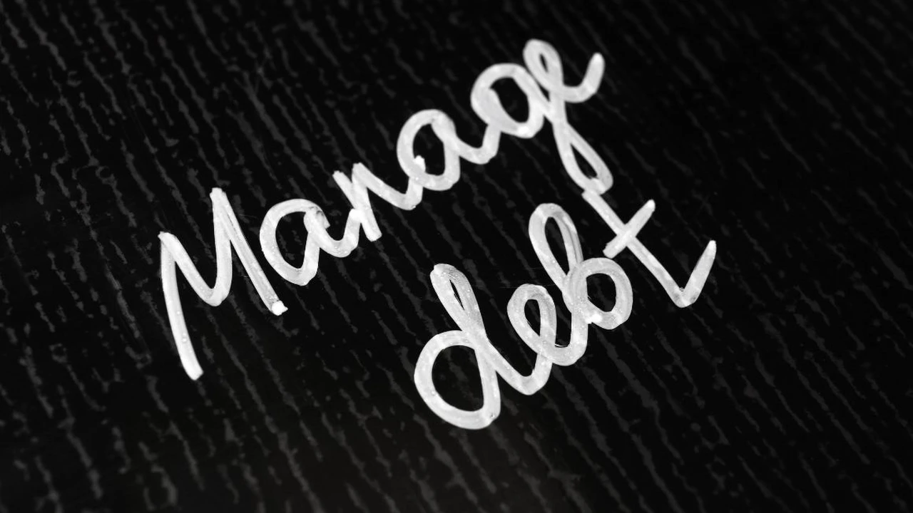 blue bowl of black bean beef tortilla soup on a board with cilantro and shredded cheese in background