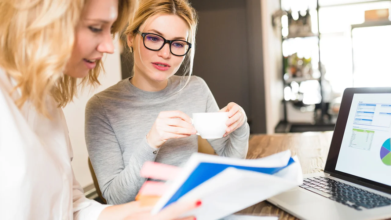 Close up on a plate of mashed potatoes, topped with baked pork chops with cream of mushroom soup, and a side of green beans.