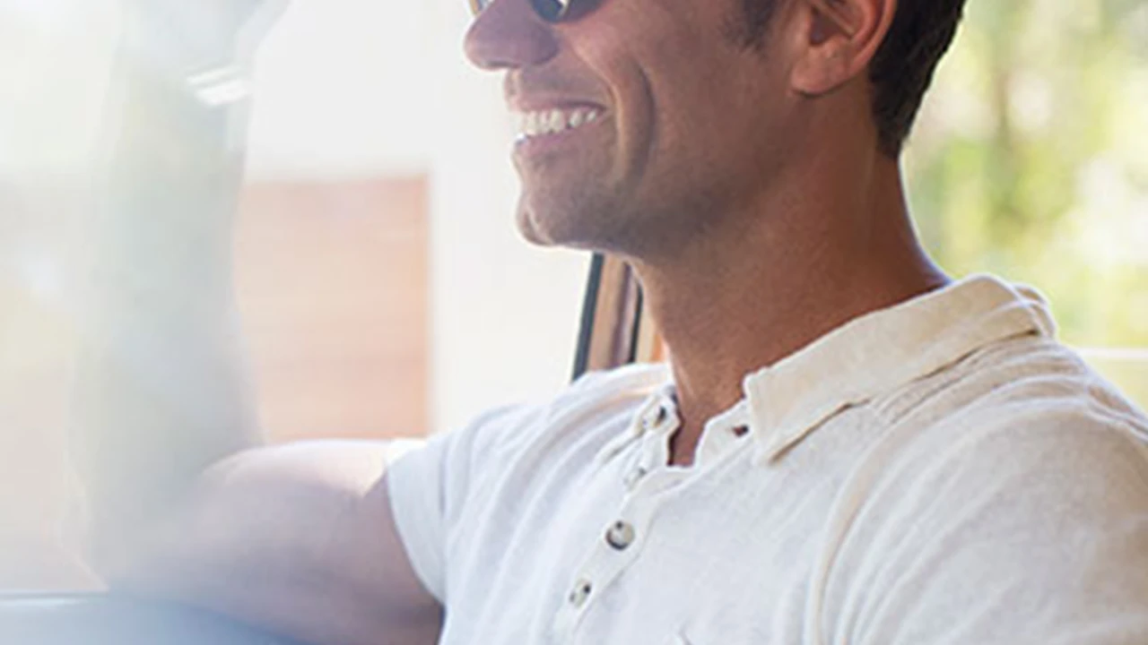 blue bowl of black bean beef tortilla soup on a board with cilantro and shredded cheese in background